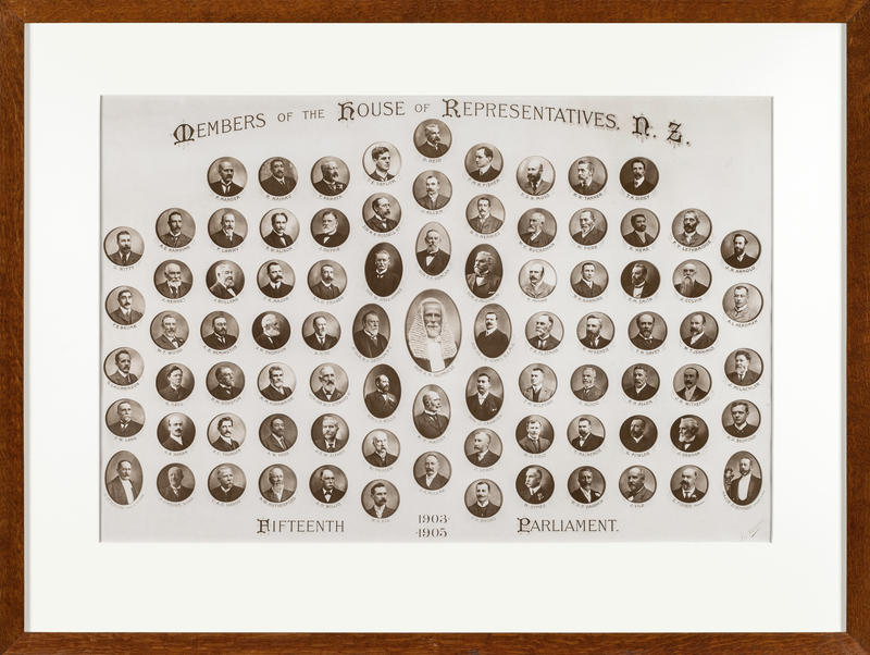 A framed photo the members of the House of Representatives from the 15th Parliament. Each members photo is circular and black and white. The speaker is in the middle of the image.